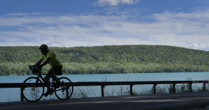 Cyclist along side coast Cooperstown Bike Tour