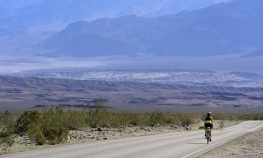 Cyclist biking in the desert Death Valley Bike Tour