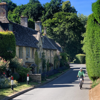 Cotswolds single cyclist rides by home vertical