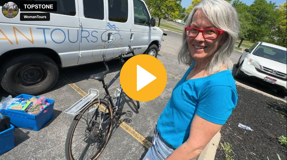 Picture of Karen standing in front of WomanTours van with a bike.