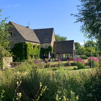 Cotswolds home seen through greenery