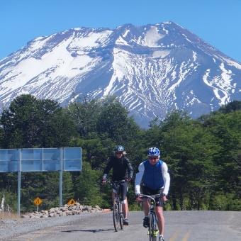 Two cyclists in Chile below Lonquimay Volcano