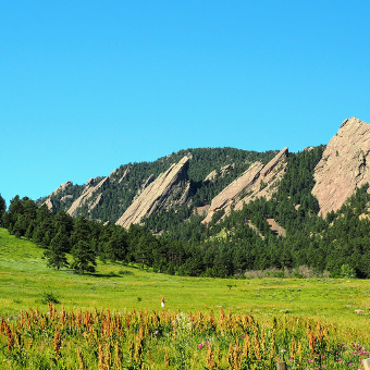 field and mountains in the Boulder Bike Tour in CO