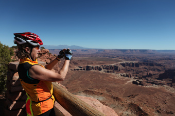 Cyclist taking a picture of scenery during Moab Arches and Canyonlands Bike Tour