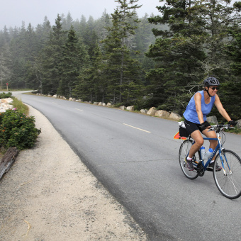 Cyclist on bike path during Maine Acadia National Park Bike Tour