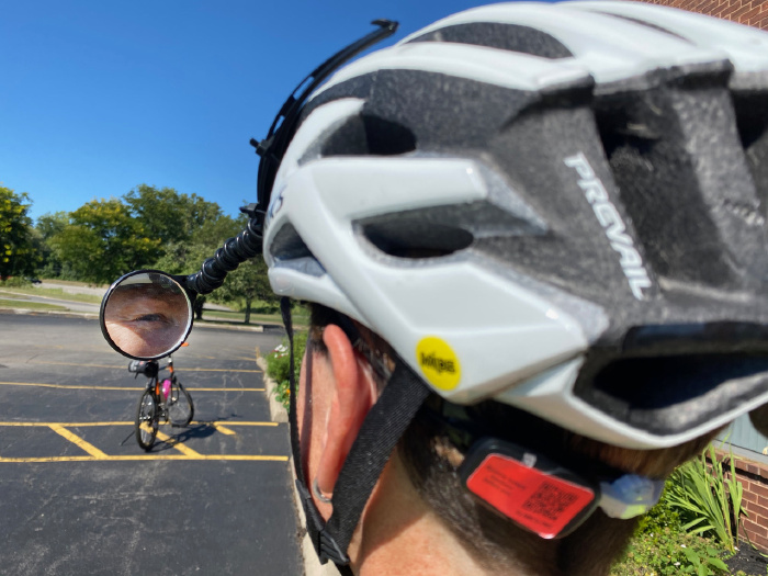 Jackie demonstrates using a bike helmet mirror, which helps her monitor the traffic behind her. 