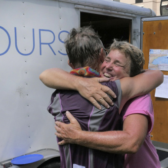 2 Cyclist hugging at the end of Epic Bike Tour
