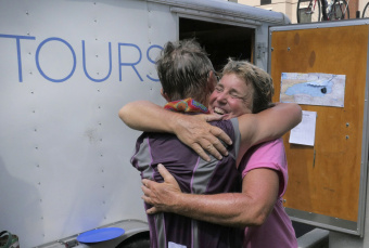 2 Cyclist hugging at the end of Epic Bike Tour