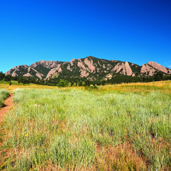 field and mountains in the Boulder Bike Tour in CO