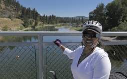 Cyclist posing for photon on bridge Idaho Greenways Bike Tour