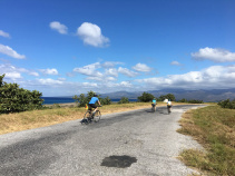 three bicyclists on road on Cuba bike tour