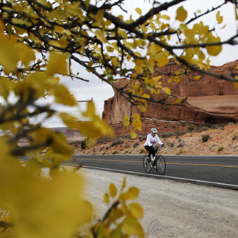 Cyclist on road during Moab Arches and Canyonlands Bike Tour