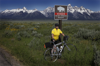 Cyclist posing for a photo by a buffalo sign Idaho Teton Valley Bike Tour
