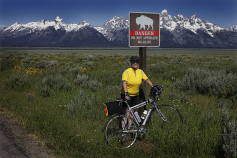 Cyclist posing for a photo by a buffalo sign Idaho Teton Valley Bike Tour
