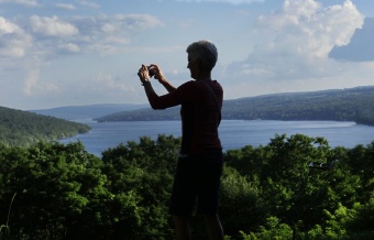 WomanTours guest taking a photo on the view Finger Lakes Bike Tour