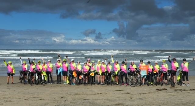 Two dozen women and their bicycles line up in front of the Pacific Ocean in San Diego before departing on a cross-country bike tour to St. Augustine.