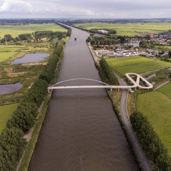 Bird's eye view of cylcists crossing a canal in the Netherlands