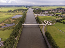 Bird's eye view of cylcists crossing a canal in the Netherlands