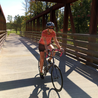 Cyclist riding on bridge Erie Canal Bike Tour