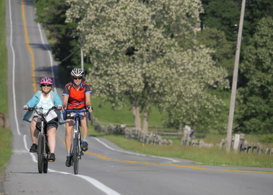 Gerri rides an ebike next to Jackie.