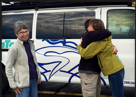 WomanTours president, Jackie hugs Nancy as Carlyn looks on before they departed with our new van headed to the west coast.