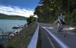 Cyclist along side river Cooperstown Bike Tour