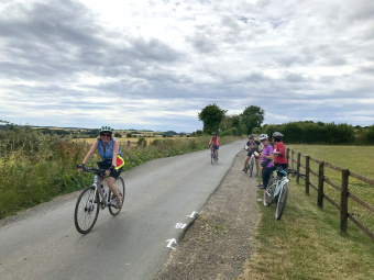 Cotswolds women on path along fence
