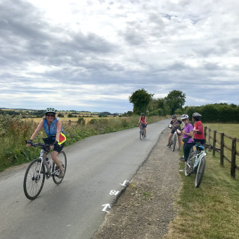 Cotswolds women on path along fence