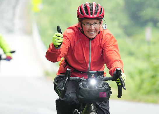 Two women cycling on a country road.