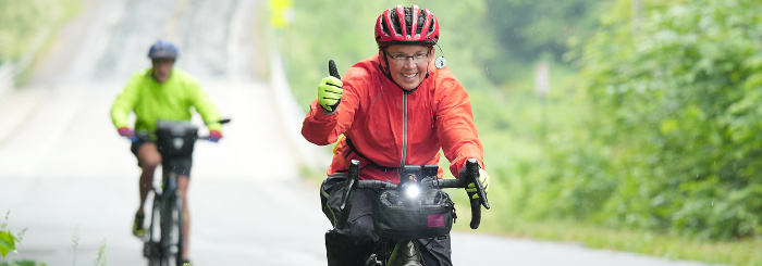 Two women cycling on a country road while on a bike tour