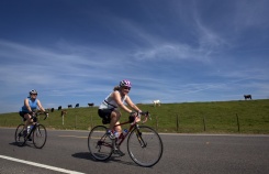 Two cyclist riding along side farm during Louisiana Bike Tour