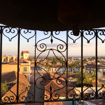 Cuba city scene as viewed through balcony railing on Cuba bike tour