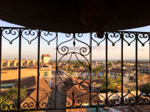 Cuba city scene as viewed through balcony railing on Cuba bike tour